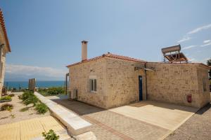a small brick building with a door on top of it at Petra & Thea Chrani Villas in Chrani