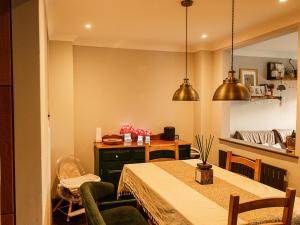 a dining room with a table and a kitchen at Sun Set House With Hot Tub in Witchford