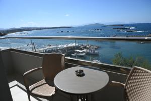 a table and chairs on a balcony with a view of the ocean at stelisia2 in Chania
