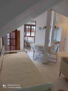 a room with a bed and a table and chairs at Thea apartments 2 in Platamonas