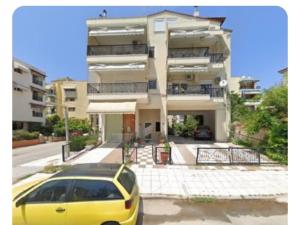 a yellow car parked in front of a building at JD Maisonette for 4 in Neoi Epivates