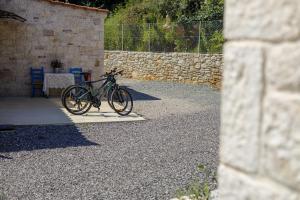 a bike parked on a stand in a courtyard at Petra & Thea Chrani Villas in Chrani +55 photos