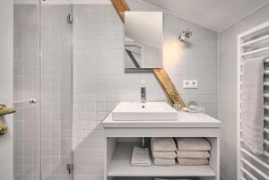 a bathroom with a sink and a mirror and towels at Hay Loft - Flensburger Förde in Westerholz +10 photos