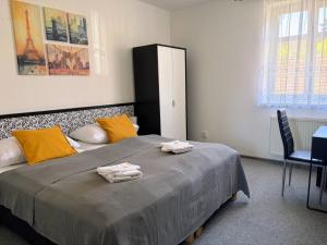 a bedroom with a large bed with towels on it at Hotel Pangea in Telč +10 photos