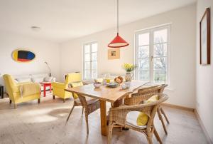 a dining room with a wooden table and chairs at Hay Loft - Flensburger Förde in Westerholz