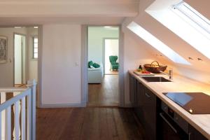 a kitchen with a staircase leading to a living room at Lake View - Flensburger Förde in Westerholz +11 photos