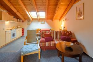 a living room with a couch and a table at Haus Seewind Warnemünde in Rostock