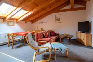 a living room with a couch and a table at Haus Seewind Warnemünde in Rostock