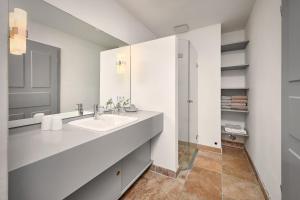 a white bathroom with a sink and a mirror at Rose Garden - Flensburger Förde in Westerholz