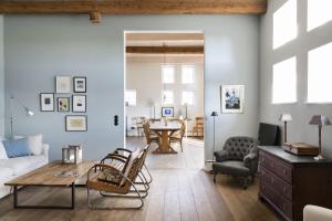 a living room with a couch and a table at Ostseehof-Kernhof in Pommerby