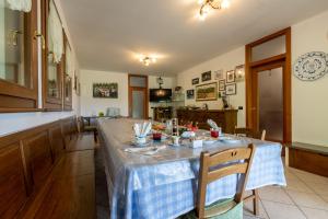a kitchen with a table with a blue table cloth on it at ROSSO DI SERA Bed & Breakfast in Tarcento +9 photos