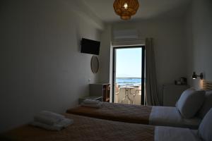 a bedroom with a bed with a view of the ocean at stelisia2 in Chania