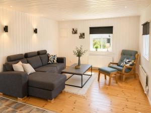 a living room with a couch and a table at Only 150 m to the nearest lake and 2,5 km to the top of Isaberg in Hestra