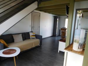 a living room with a couch and a table at Villa Soulacaise V in Soulac-sur-Mer