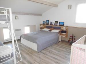 a bedroom with a bed with a ladder and a desk at Villa Soulacaise V in Soulac-sur-Mer