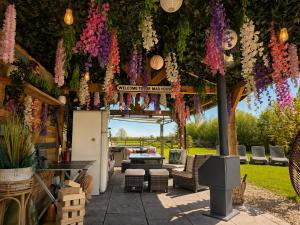 a pergola with flowers hanging from it at The Stables Luxury House with Hot tub in York