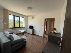 a living room with a couch and a table at Gradina in Chernomorets