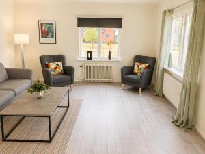 a living room with two chairs and a table at Only 150 m to the nearest lake and 2,5 km to the top of Isaberg in Hestra