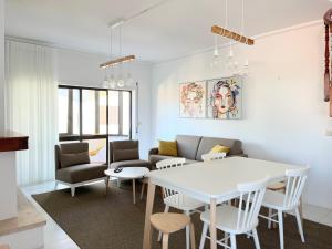a living room with a white table and chairs at Salt Beach Apartments B in Viana do Castelo +8 photos