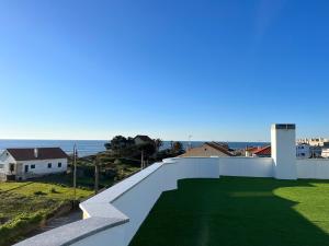 a view of the ocean from the balcony of a house at Salt Beach Apartments B in Viana do Castelo
