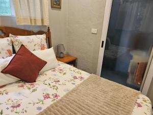 a bedroom with a bed with flowers on it at Bavarian Getaway in Kloof +12 photos