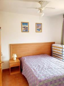 a bedroom with a bed and a chair in it at T2 les pieds dans l eau avec piscine in San-Nicolao +19 photos