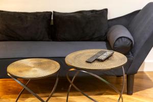 two tables with two remote controls on top of a couch at Le Carpe Diem - Détente & Bien-être - Balnéo, Sauna, CLIM, Terrasse, Parking privé in Dole