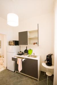 a small kitchen with a sink and a refrigerator at San Domenico in Noto