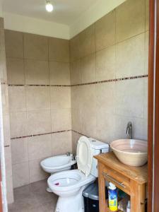 a bathroom with a toilet and a sink at Casa Parque Rio Uruguay in Concordia +12 photos