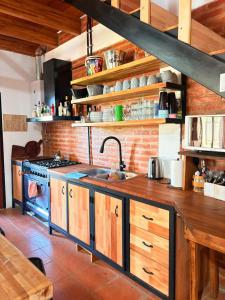 a kitchen with a sink and a stove at Casa Parque Rio Uruguay in Concordia