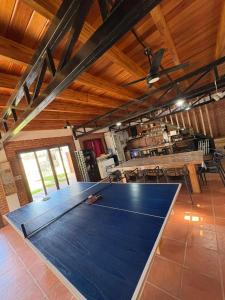 a ping pong table in the middle of a room at Casa Parque Rio Uruguay in Concordia