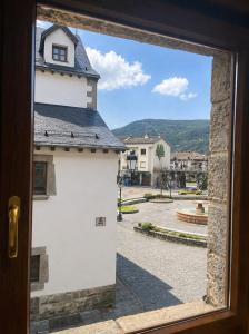 a window view of a street from a building at Biescas Suites in Biescas +12 photos