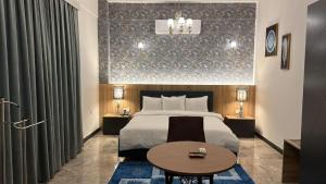 a hotel room with a bed and a table at Motel Victoria Sky in Erbil