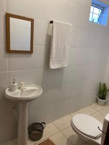 a bathroom with a sink and a toilet at Aconchego da Si AP in Nova Mutum