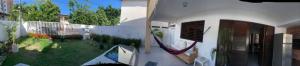 two pictures of a house with a yard and a yard at Pousada e Hostel Praia do poço in Cabedelo