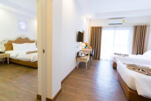 Voodi või voodid majutusasutuse Hi Chiangrai Hotel toas