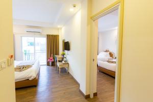 Voodi või voodid majutusasutuse Hi Chiangrai Hotel toas