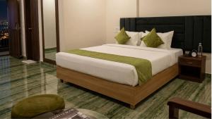 a bedroom with a large bed with green pillows at MAHFIL-e-MOTIJHEEL, MOTIJHEEL PARK AND RESORT in Lālbāgh +33 photos