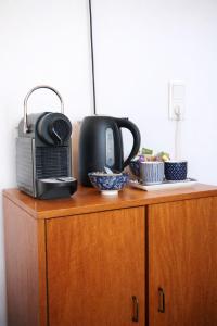 a wooden cabinet with a microwave and a radio on it at Koffie&kussens in Middelburg