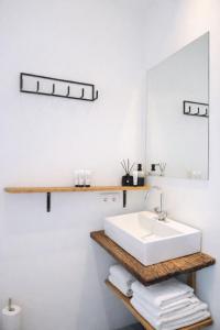 a bathroom with a white sink and a mirror at Koffie&kussens in Middelburg +40 photos
