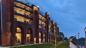 a large brick building with arches on the side of it at MAHFIL-e-MOTIJHEEL, MOTIJHEEL PARK AND RESORT in Lālbāgh