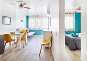 a room with a table and chairs and a bedroom at Apartamentos Eldorado in Lloret de Mar