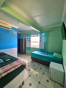 a room with two beds and a window at Hotel Marajoara Breves in Breves