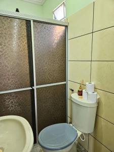 a bathroom with a toilet and a shower and a sink at Hotel Marajoara Breves in Breves +34 photos