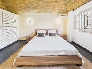 a bedroom with a large bed in a room at Villa Épuré Tribale in Darou Rhamane +17 photos