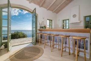a kitchen with a bar with a view of the ocean at Villa Athena in Agios Nikolaos