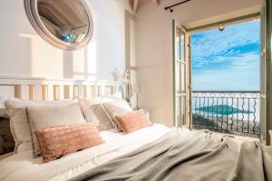 a bedroom with a bed with a view of the ocean at Villa Athena in Agios Nikolaos