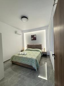 a bedroom with a bed in a white room at CARISSA SUITES a in Afantou