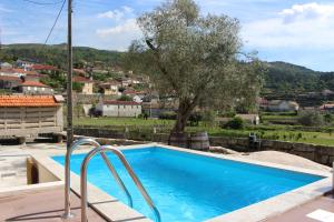 a blue swimming pool with a view of a city at Recanto da Malhadoira in Currais