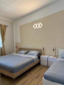 a bedroom with two beds and two night stands at Amore in Vir